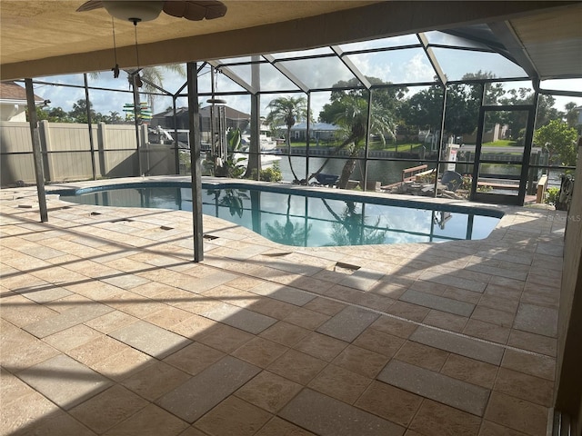 727 Flamingo Dr, Apollo Beach, FL 33572 - swimming pool with a patio area, glass enclosure, a ceiling fan, and a water view