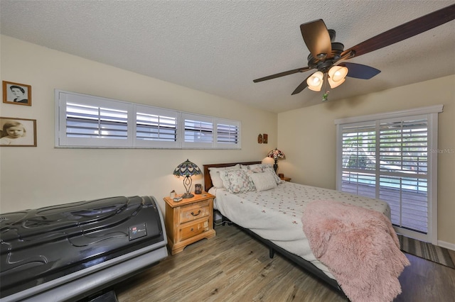 727 Flamingo Dr, Apollo Beach, FL 33572 - bedroom with wood finished floors, a textured ceiling, and ceiling fan