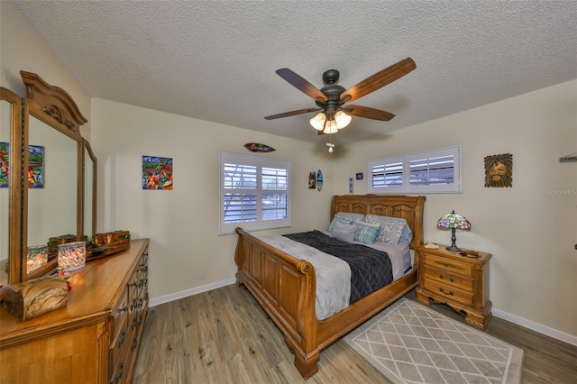 727 Flamingo Dr, Apollo Beach, FL 33572 - bedroom featuring light wood-style flooring, a textured ceiling, and a ceiling fan