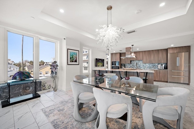 dining room with visible vents, recessed lighting, an inviting chandelier, marble finish floor, and a raised ceiling