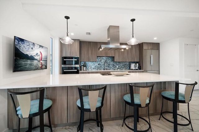 kitchen featuring tasteful backsplash, built in fridge, island exhaust hood, and modern cabinets