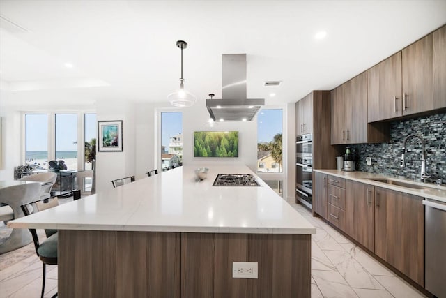 kitchen with a kitchen island, island exhaust hood, a sink, decorative backsplash, and marble finish floor