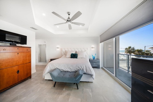 bedroom with visible vents, a raised ceiling, a ceiling fan, and access to outside