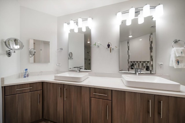 bathroom featuring double vanity, visible vents, and a sink