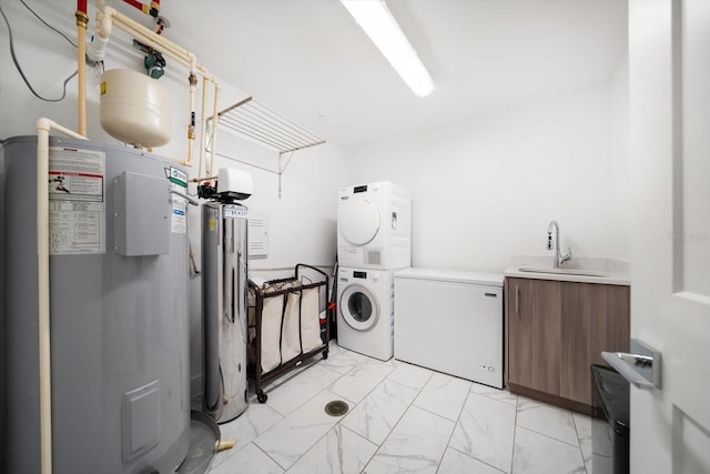 laundry area featuring cabinet space, water heater, a sink, stacked washer / dryer, and marble finish floor