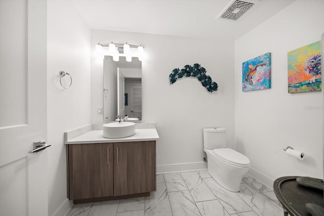 bathroom with visible vents, toilet, marble finish floor, baseboards, and vanity