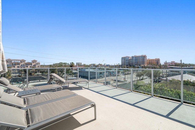 view of patio with a view of city and a balcony