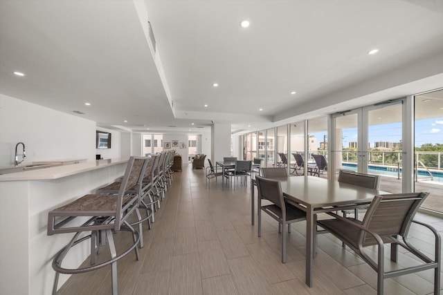 dining room featuring recessed lighting and wood tiled floor