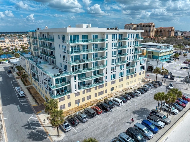 view of building exterior featuring a view of city and uncovered parking