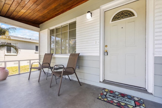 view of exterior entry with a porch