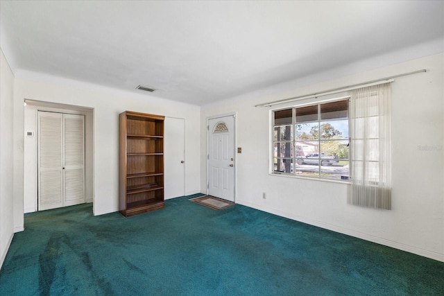 interior space with visible vents, baseboards, and carpet