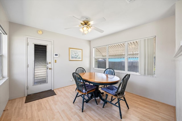 dining area featuring light wood-style floors and a ceiling fan