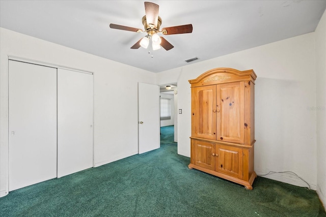 unfurnished bedroom featuring a closet, visible vents, ceiling fan, and carpet floors