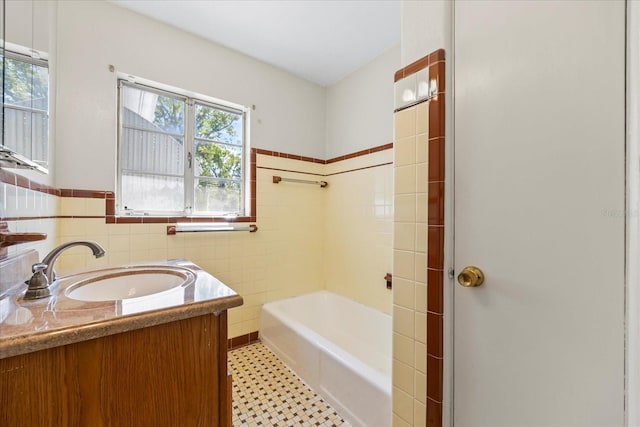 full bathroom with vanity, tile walls, a shower, and a washtub