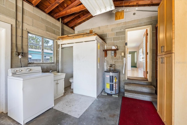 interior space with concrete block wall, washer / clothes dryer, electric water heater, and a sink