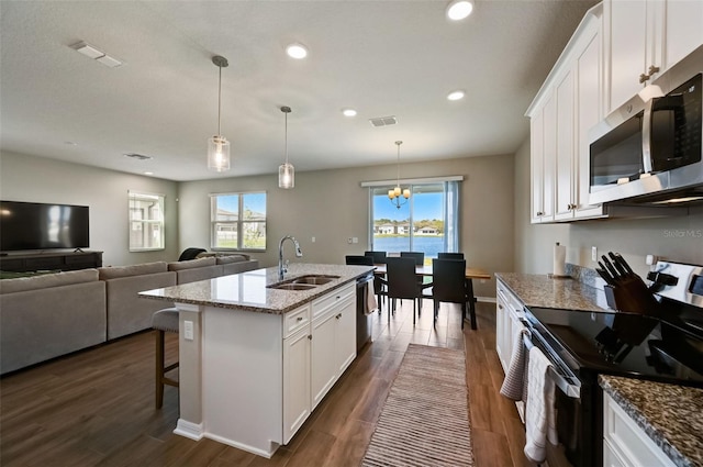 kitchen with white cabinetry, stainless steel appliances, dark wood-type flooring, a sink, and visible vents