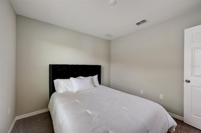 carpeted bedroom featuring baseboards and visible vents