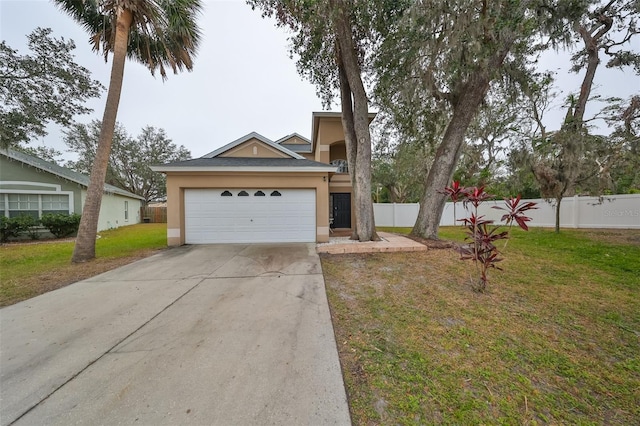 view of front of house featuring a front lawn, an attached garage, driveway, and stucco siding