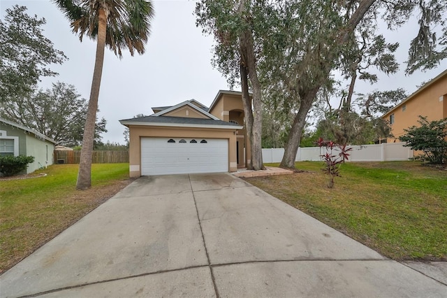 view of front facade featuring an attached garage, fence, a front yard, stucco siding, and driveway