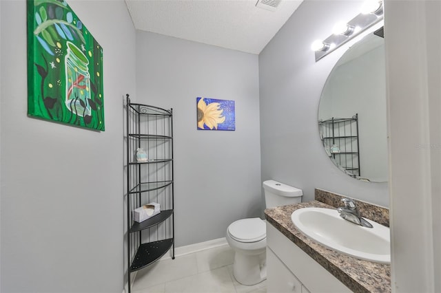 half bathroom featuring tile patterned flooring, baseboards, toilet, vanity, and a textured ceiling