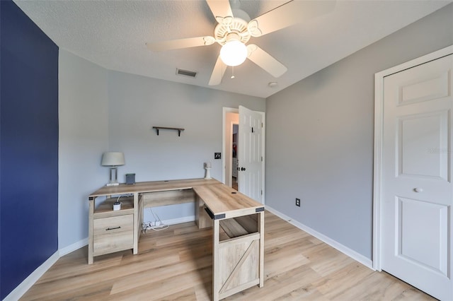 home office with ceiling fan, visible vents, baseboards, and light wood-style flooring