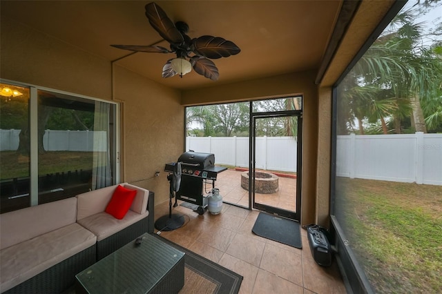 sunroom / solarium featuring ceiling fan