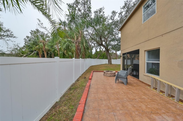 view of patio featuring an outdoor fire pit and a fenced backyard