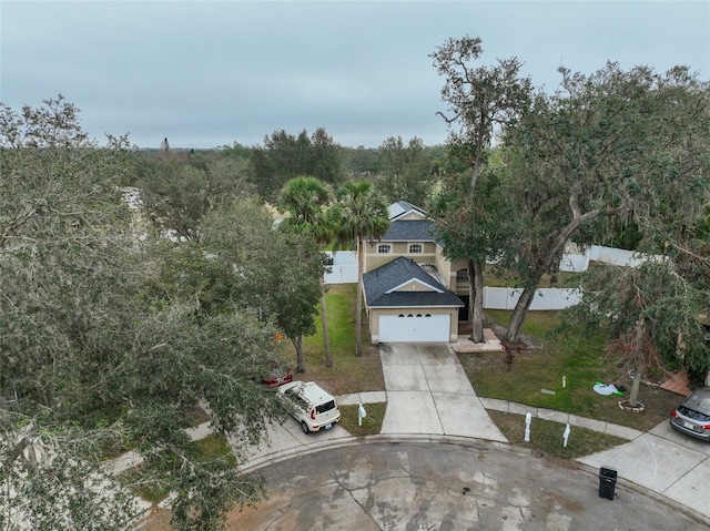 view of front of home with driveway, a front lawn, a garage, and fence