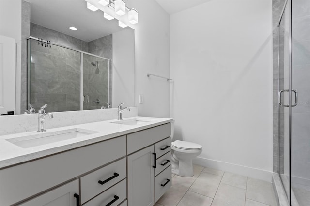 full bath featuring a sink, double vanity, a stall shower, and tile patterned floors