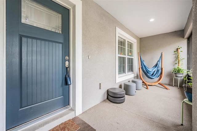 entrance to property featuring stucco siding