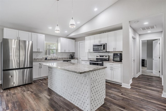 kitchen featuring visible vents, a sink, a kitchen island, appliances with stainless steel finishes, and lofted ceiling