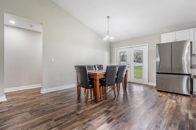 dining room with french doors, baseboards, dark wood-type flooring, and vaulted ceiling