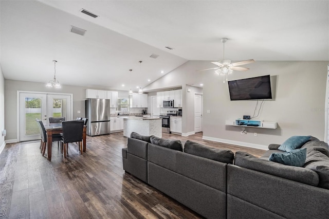 living room with visible vents, baseboards, vaulted ceiling, french doors, and dark wood-style floors