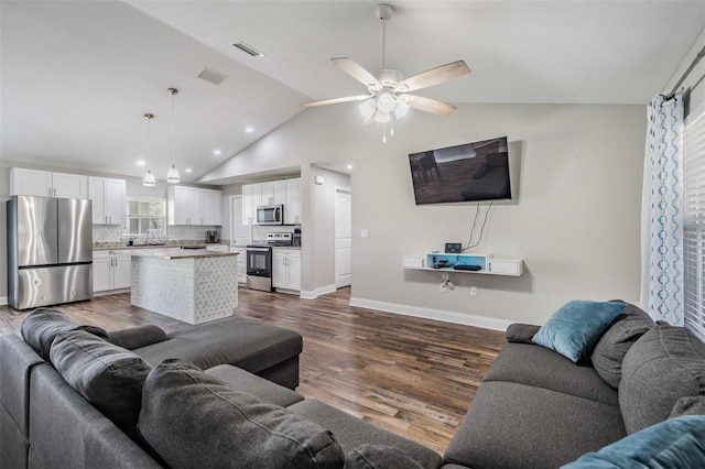 living room featuring visible vents, a ceiling fan, baseboards, lofted ceiling, and dark wood-style flooring