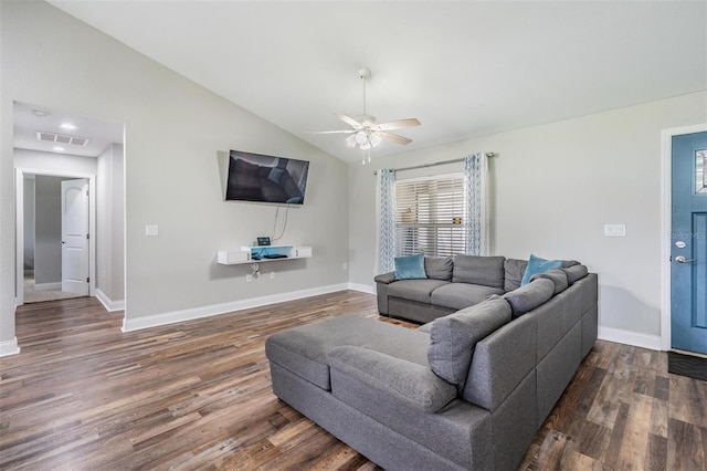 living room featuring visible vents, lofted ceiling, baseboards, and wood finished floors