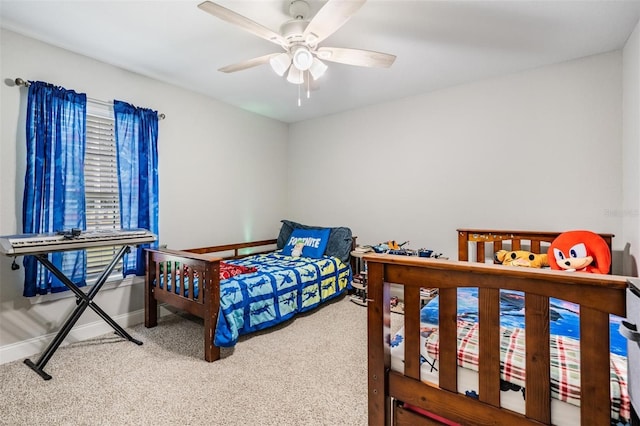 bedroom with carpet flooring, baseboards, and ceiling fan