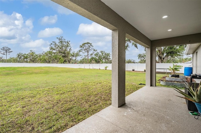 view of patio featuring a water view and a fenced backyard