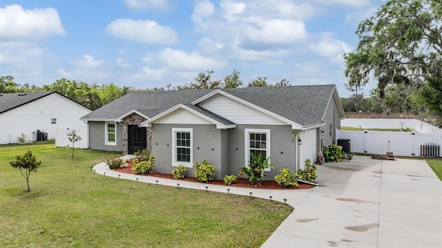 view of front facade with a gate, fence, a shingled roof, concrete driveway, and a front lawn