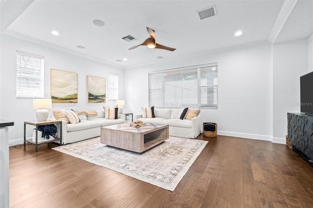 living area with visible vents, crown molding, and dark wood-style flooring