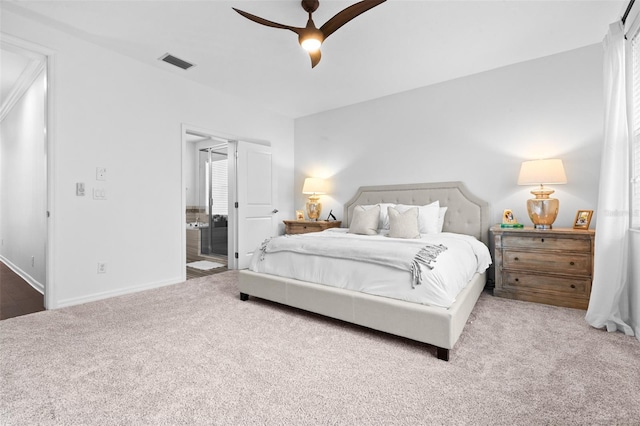 carpeted bedroom with visible vents, baseboards, and a ceiling fan