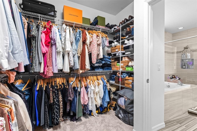 walk in closet featuring carpet