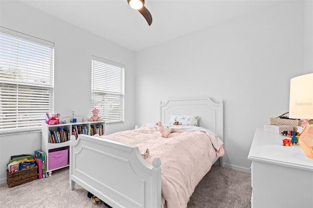 carpeted bedroom featuring baseboards and a ceiling fan