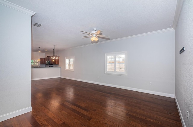 unfurnished living room with visible vents, crown molding, baseboards, and dark wood-style flooring