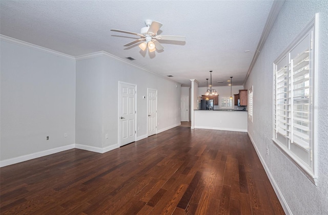 unfurnished living room with dark wood-style floors, visible vents, ceiling fan, a textured ceiling, and crown molding