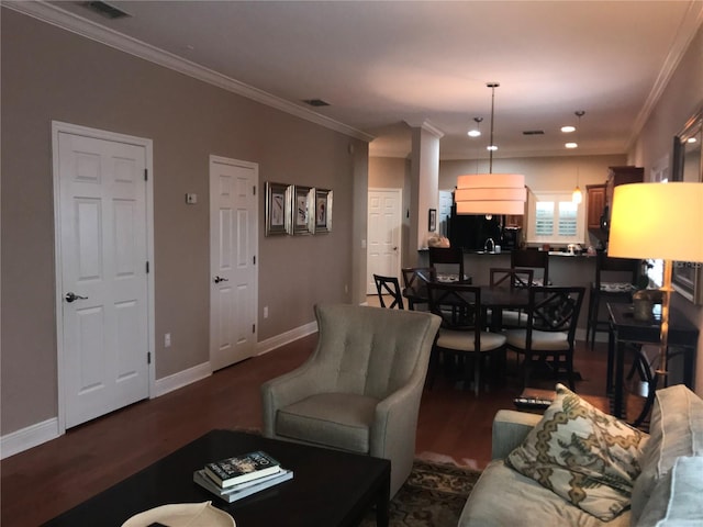 living room featuring visible vents, crown molding, and wood finished floors