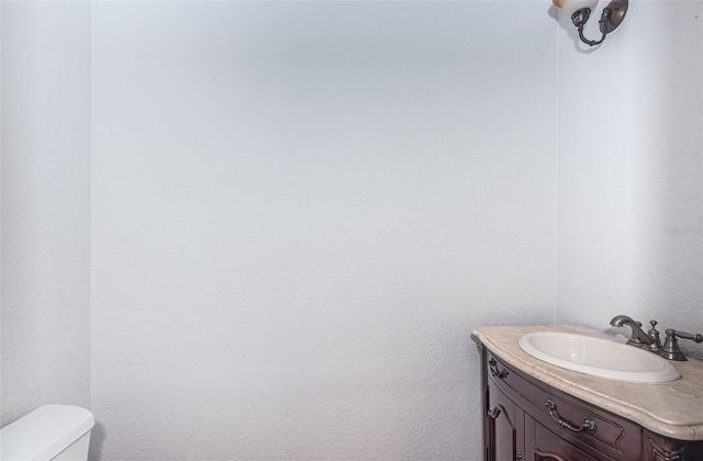 bathroom featuring toilet and vanity