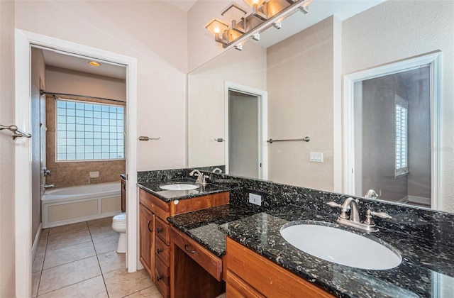 full bathroom with a sink, toilet, double vanity, and tile patterned floors