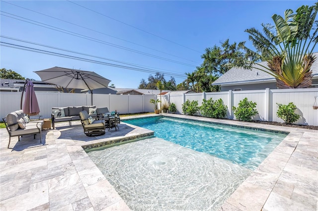 view of swimming pool with outdoor lounge area, a patio area, a fenced in pool, and a fenced backyard