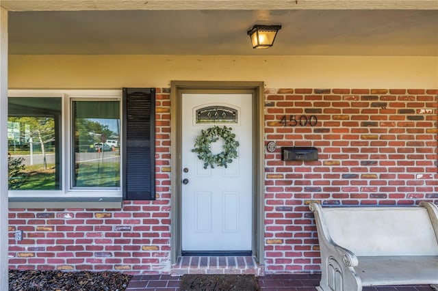 entrance to property with brick siding