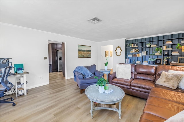 living room featuring visible vents, baseboards, crown molding, and light wood-style floors